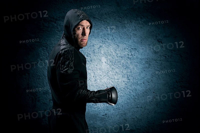 Mixed martial artist goes to battle in a sweatshirt. Concept of mma