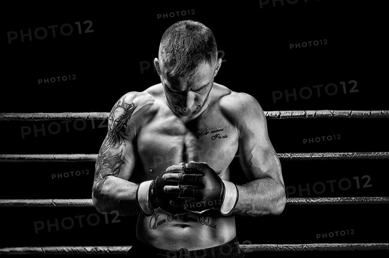 Mixed martial artist posing on a black background. Concept of mma