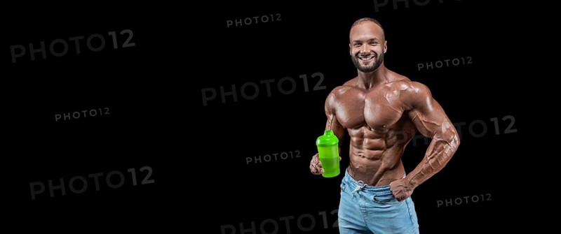 Isolated muscular man on a black background. Bodybuilding and fitness concept. Panorama.