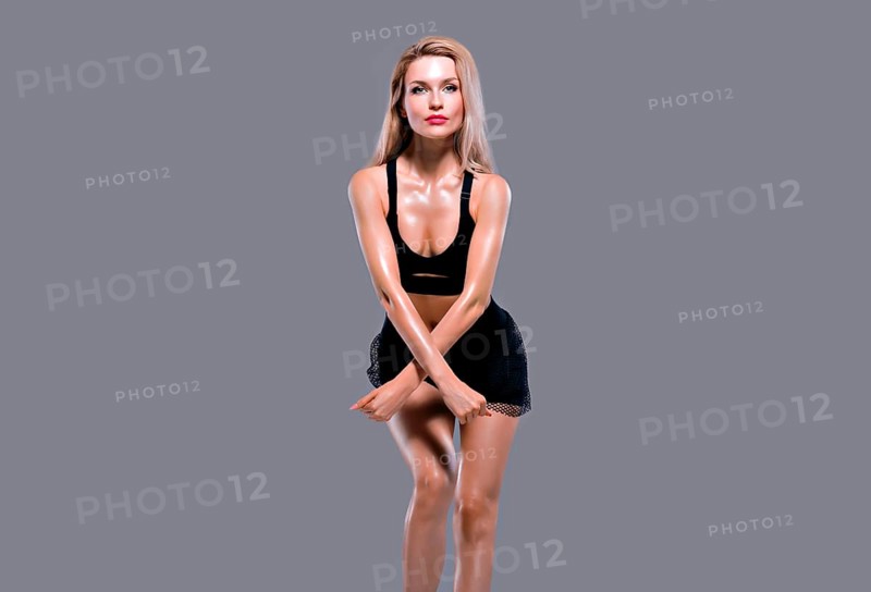 Charming sporty girl posing in sportswear and showing her chic body.