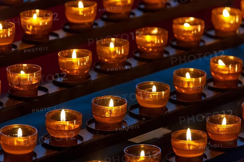 Burning sacrificial candles in a church