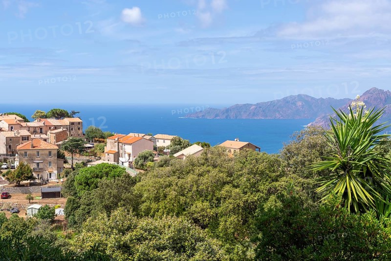The Corsican village of Piana with the rocky coast of the Gulf of Porto in the background