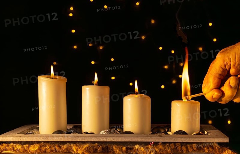 Light the fourth Advent candle with a match