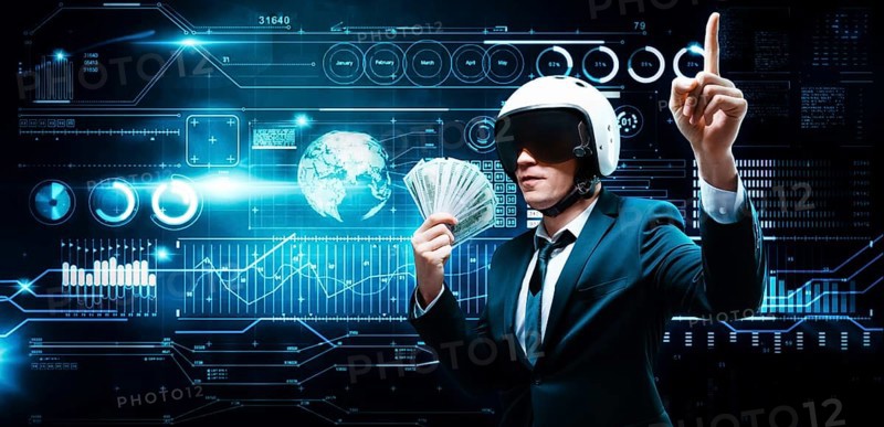 Portrait of a businessman in a suit and aviator helmet. He made a fan of a pack of hundred-dollar bills. Business concept.