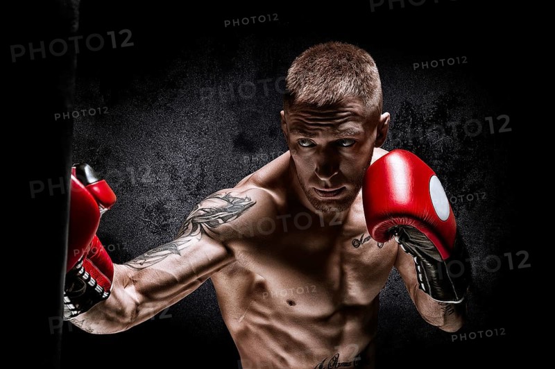Boxer punches the bag. Training a professional athlete. The concept of mma