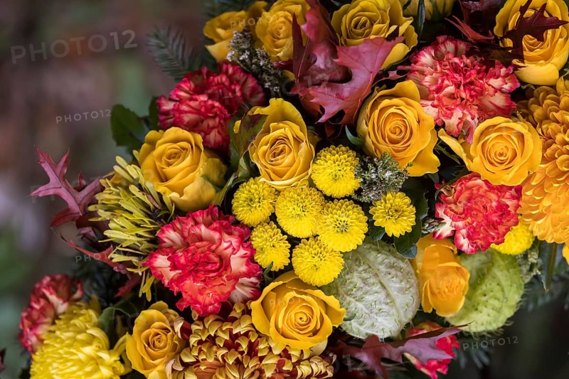 Funeral wreath with flowers at a grave