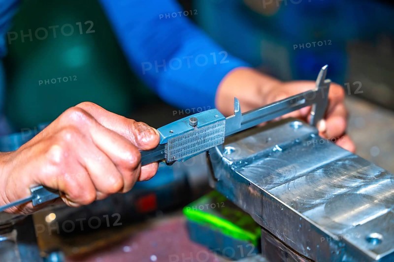 Operator with a cut finger working in a company with milling cutters in a numerical control workshop