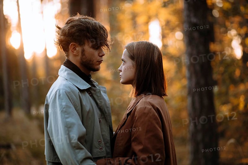 Romantic couple of lovers on a date in the park in cold weather. Fashionable couple in coat