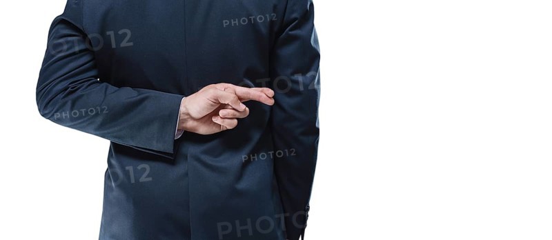 Image of a man's hands with crossed fingers on a white background. Back view. Business concept.