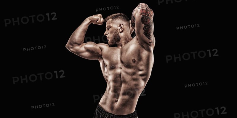 Young muscular guy posing in the studio. Fitness and nutrition concept.