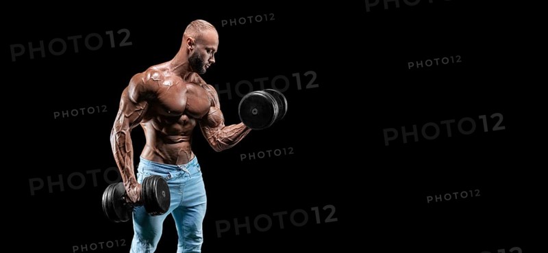Isolated muscular man on a black background. Bodybuilding and fitness concept. Panorama.