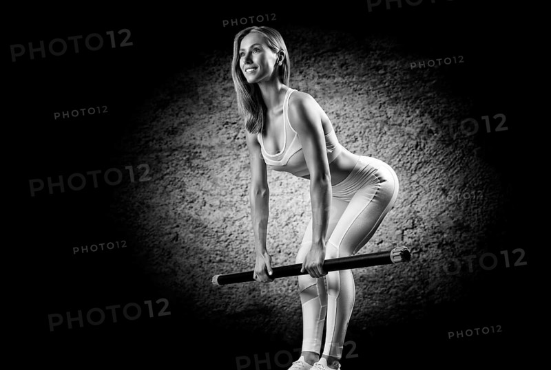 Charming girl does an exercise called deadlift. Bodybar. The concept of fitness