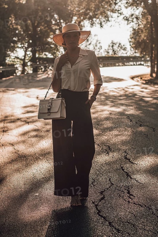 Portrait of a charming girl walking in a park in Florence. The concept of tourism