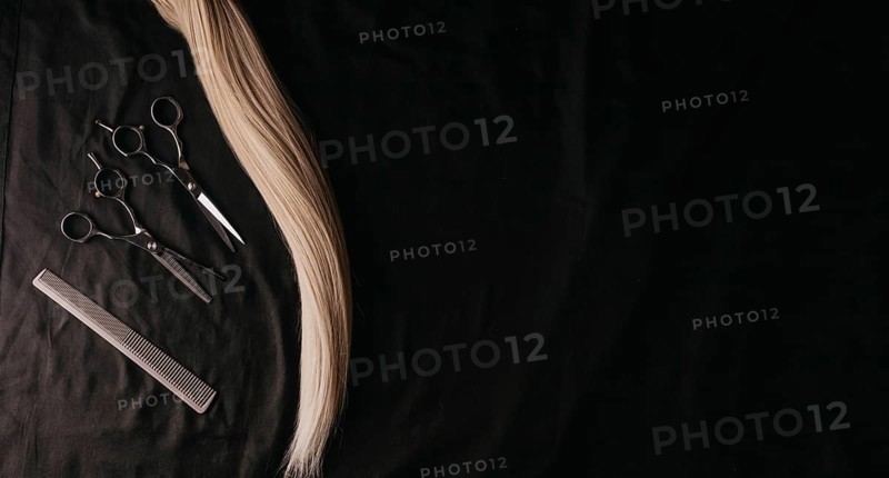 Natural hair of different colors with scissors and comb. concept of hair care and hairdressing services