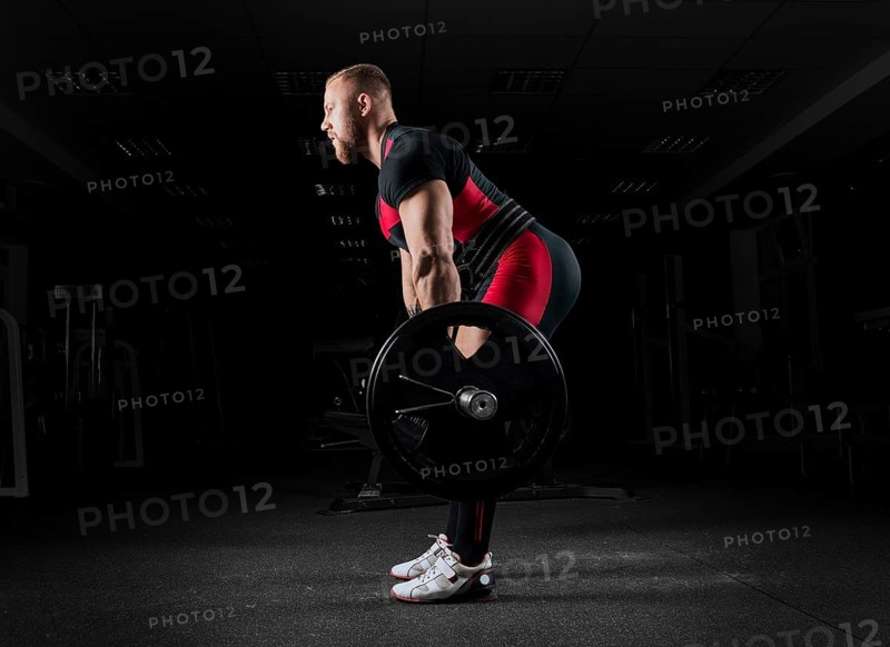 The weightlifter performs an exercise called deadlift. He fixed the weight