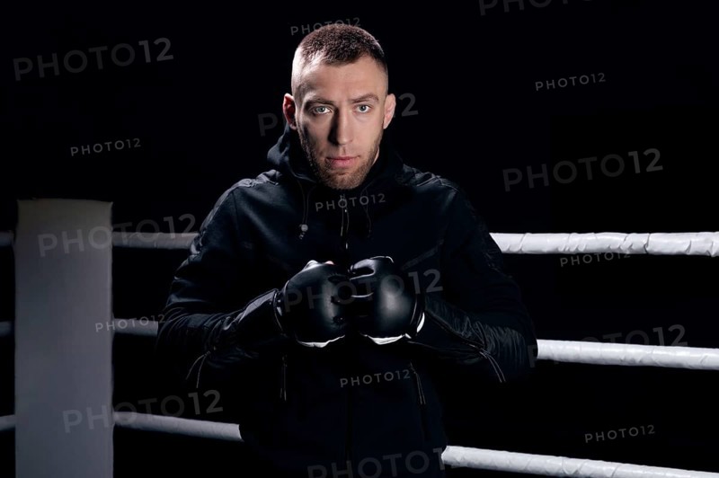 Mixed martial artist stands with his hands up. Concept of mma