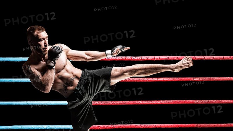 Kickboxer posing in the ring. Middle Kick. The concept of mma