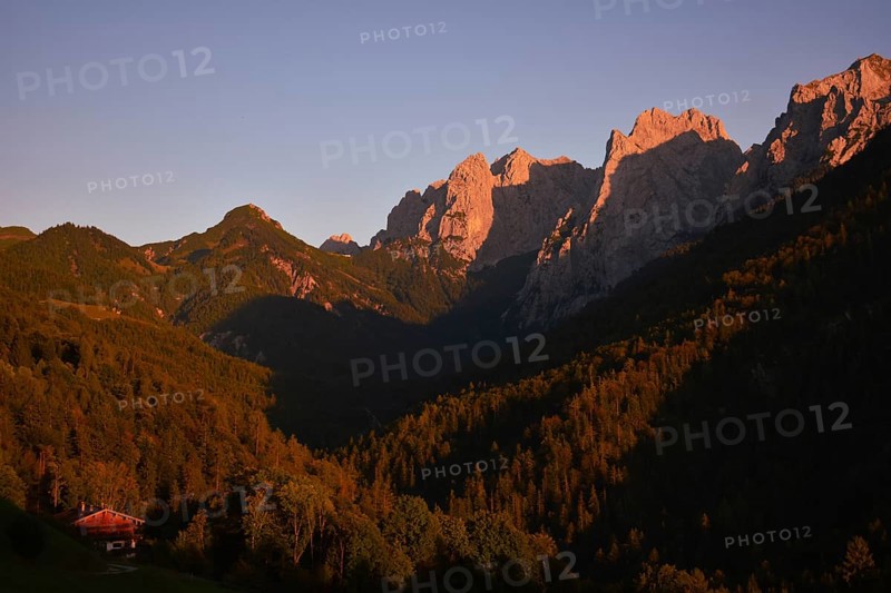 The last rays of sunlight illuminate the peaks of the Wilder Kaiser