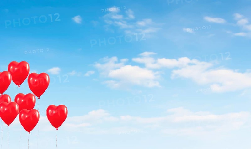Multiple red heart-shaped balloons floating up into a clear blue sky with clouds AI generated