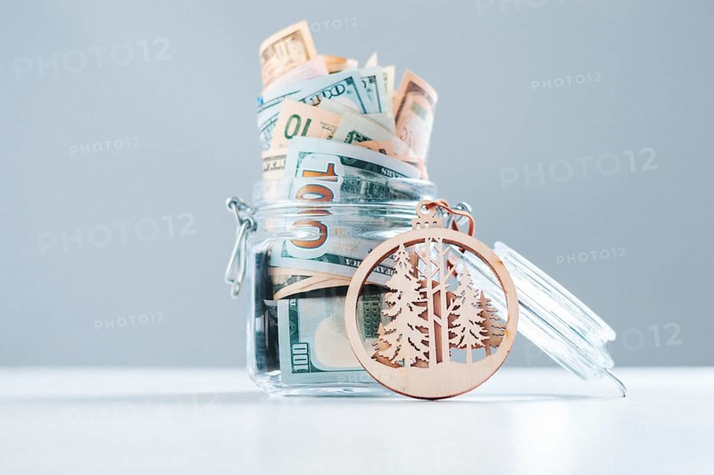 Glass piggy bank full of money. The concept of protecting the forest