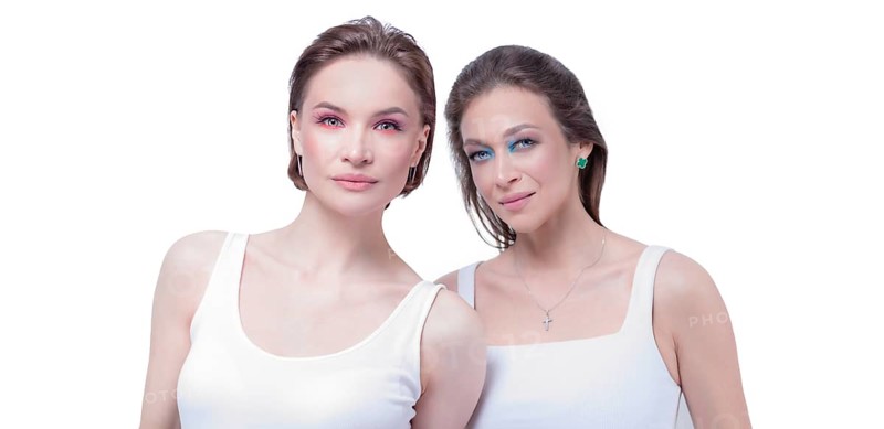 Portrait of two beautiful girls with defiant make-up on a white background. Female friendship concept. High quality