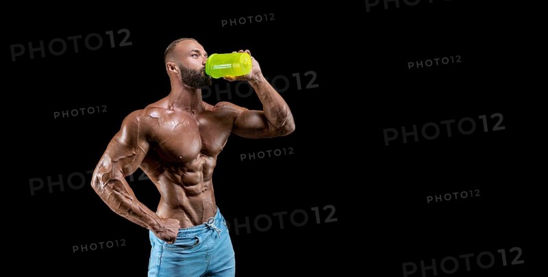 Isolated muscular man on a black background. Bodybuilding and fitness concept. Panorama.