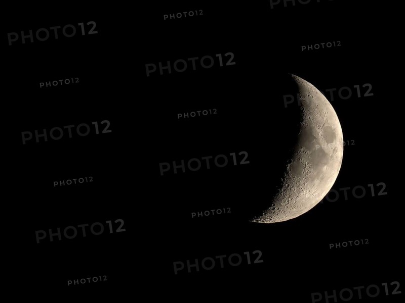 Waxing crescent moon seen with telescope