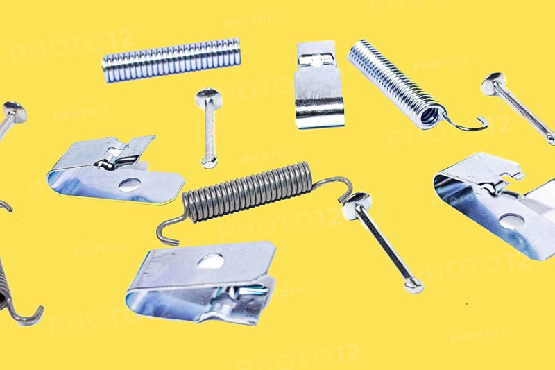 Parking brake springs and clamps repair kit on yellow isolated background
