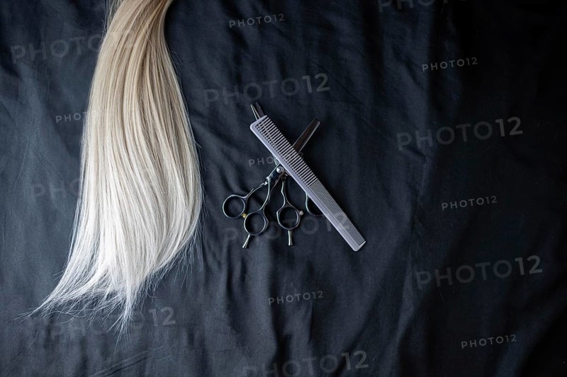 Natural hair of different colors with scissors and comb. concept of hair care and hairdressing services