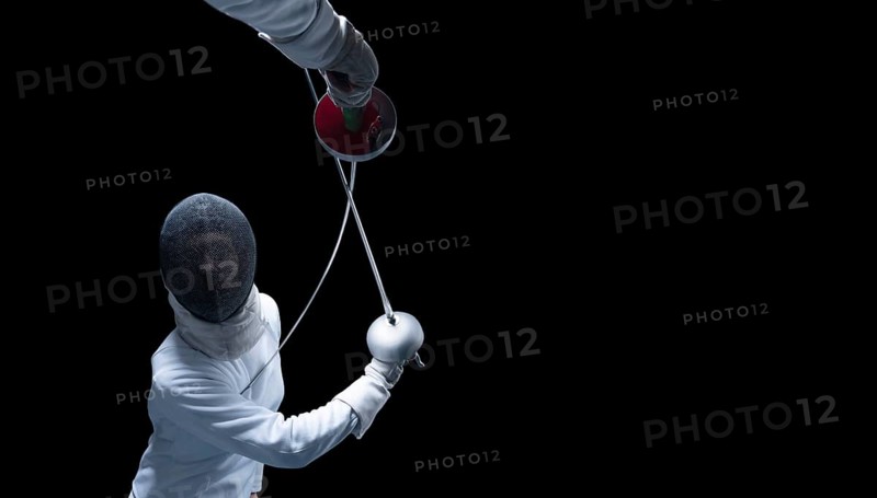 Two fencers are fighting in a tournament. The concept of fencing.