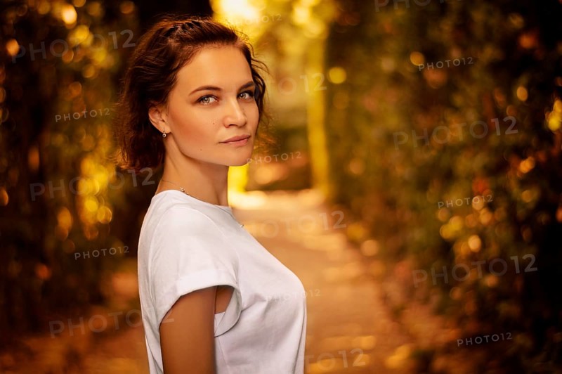 Portrait of a charming girl in the Mystic Sunny Alley in Boboli Gardens.