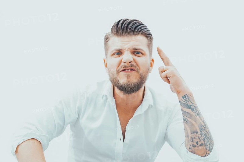 Angry man threatens his opponent. The concept of domestic violence