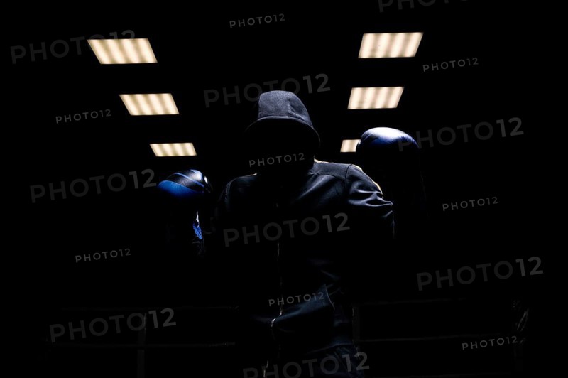 Fighter without a face is standing with his hands up. The concept of boxing