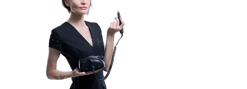 Portrait of a charming woman with a manicure device. Manicure and pedicure concept. Nails artist