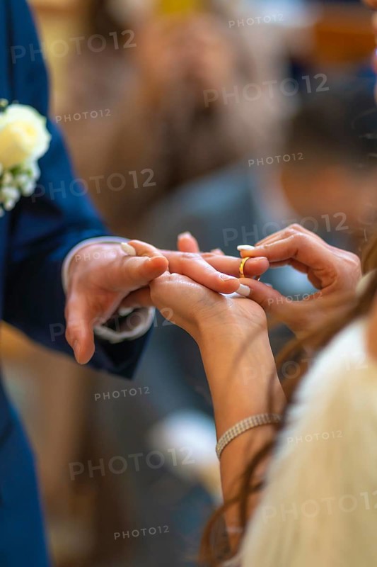 Bride about to put the ring on the groom at a beautiful wedding