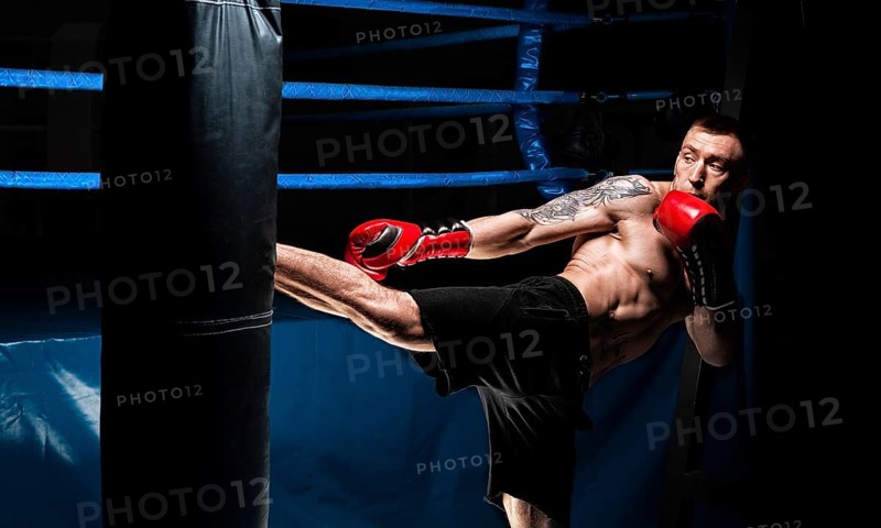 Kickboxer kicks the bag. Training a professional athlete. The concept of mma