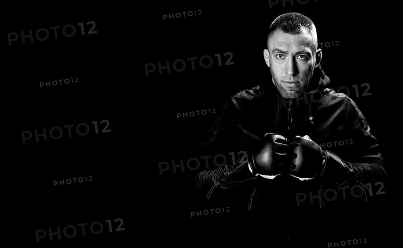 Mixed martial artist stands with his hands up. Concept of mma