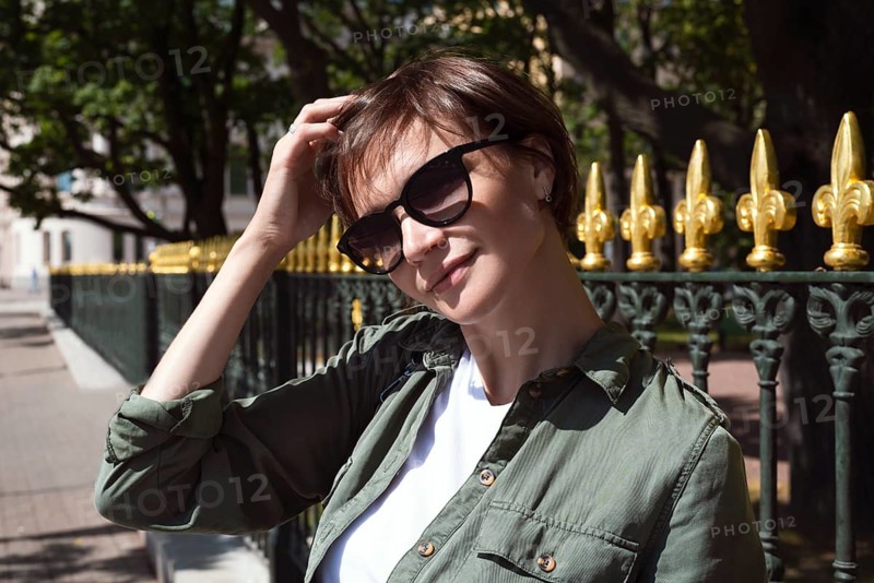 Portrait of a stylish woman in sunglasses. Happiness