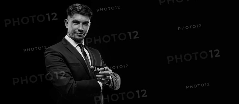 Portrait of a stylish man in a suit with a cigar. Business concept.
