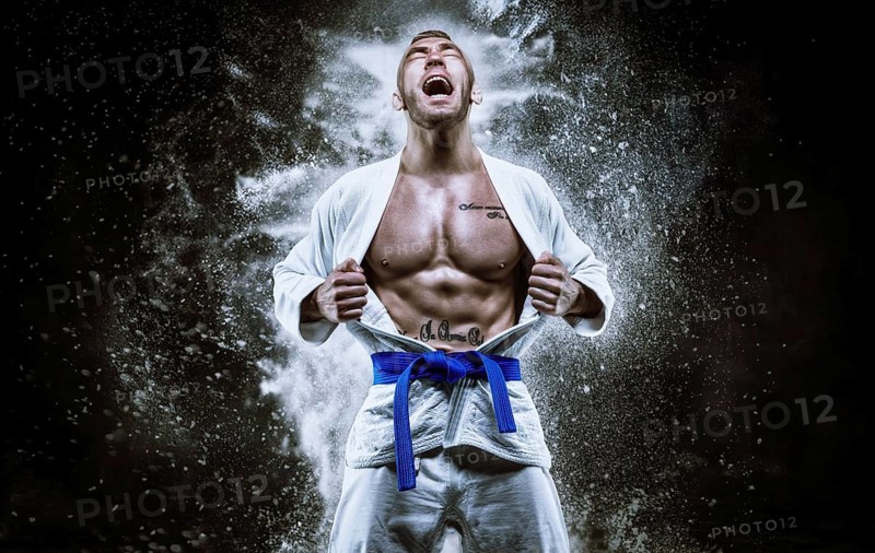 Professional athlete in a kimono screams emotionally. The concept of karate and judo competitions.