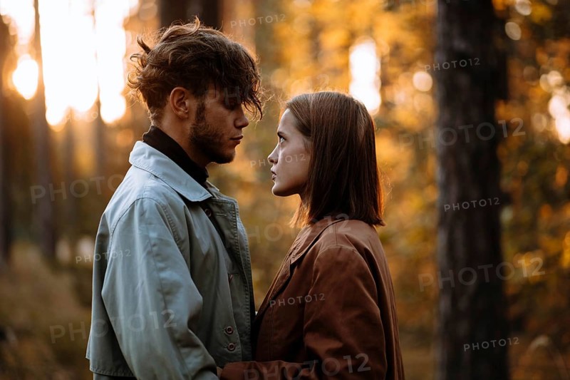 Romantic couple of lovers on a date in the park in cold weather. Fashionable couple in coat