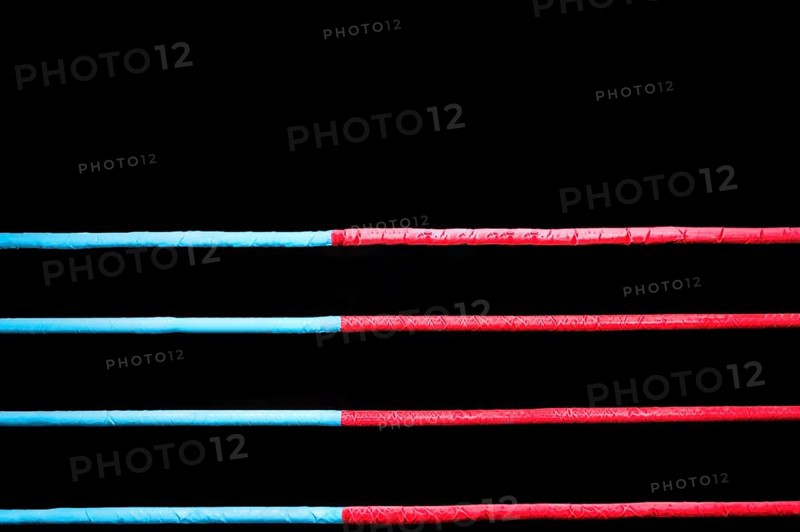 Boxing ring ropes on a black background. The concept of sports
