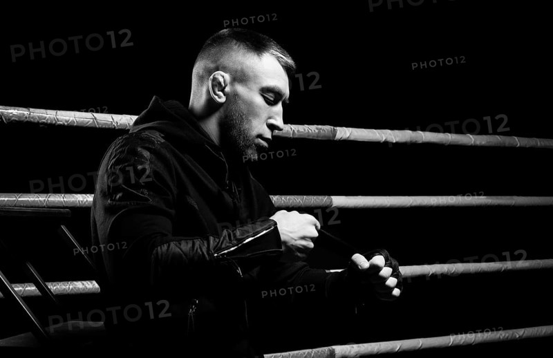 Mixed martial artist wraps bandages around his fist. Concept of mma