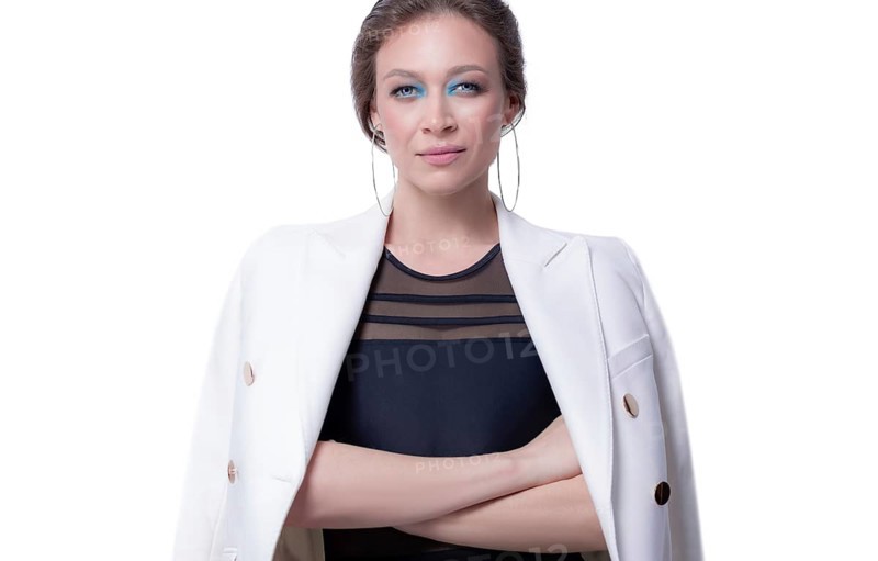 Portrait of a beautiful business woman in a white jacket. White background. The concept of management