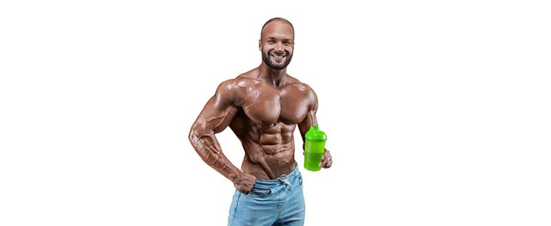 Athlete posing with a shaker in his hand on a white background. Fitness