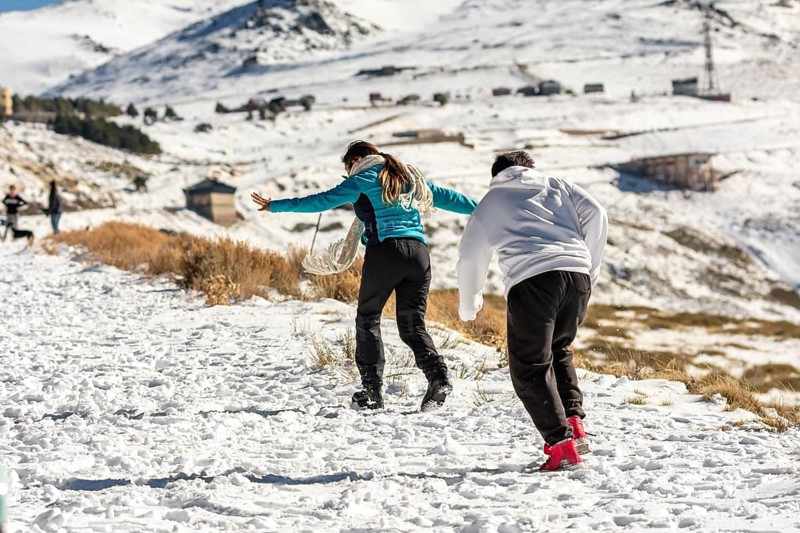 Icy adventures await! A Latino family revels in the snowy hills of Sierra Nevada
