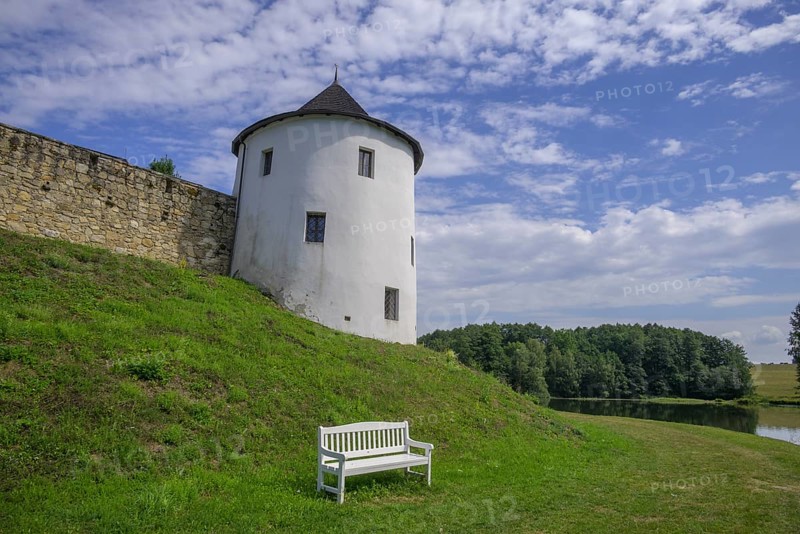 Tower of the fortified village and white bench