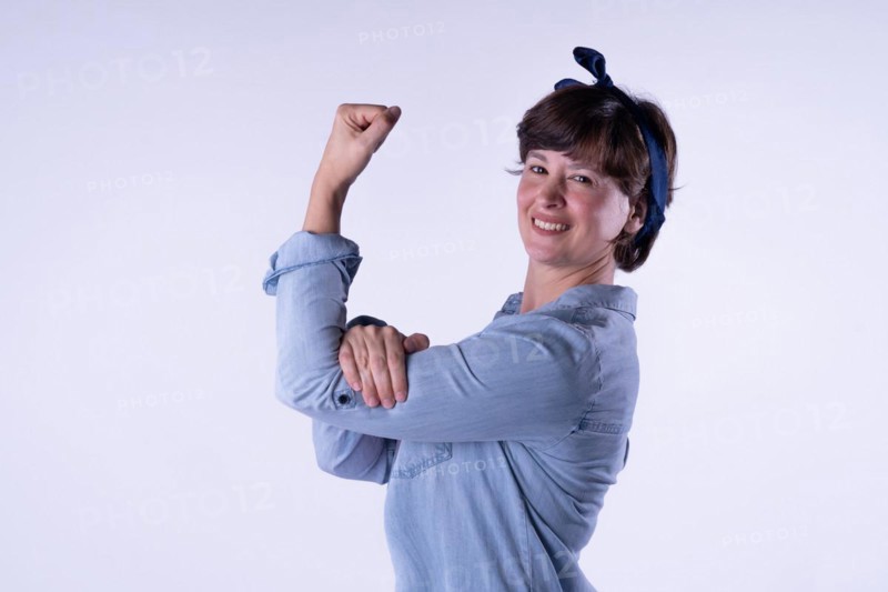 Short-haired girl showing strong arm muscle isolated. Concept WomenÂ´s day. Copy space. Portrait isolated on white background