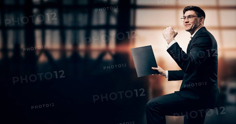 Portrait of a man in a business suit. He is standing at the airport with his hands up. VIP transportation. Private airlines. Charter flights.