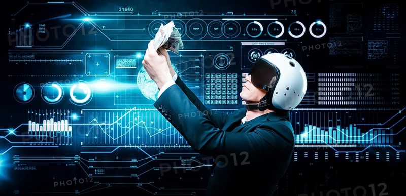 Portrait of a businessman in a suit and aviator helmet. He holds a bundle of hundred-dollar bills in front of him. Business concept.